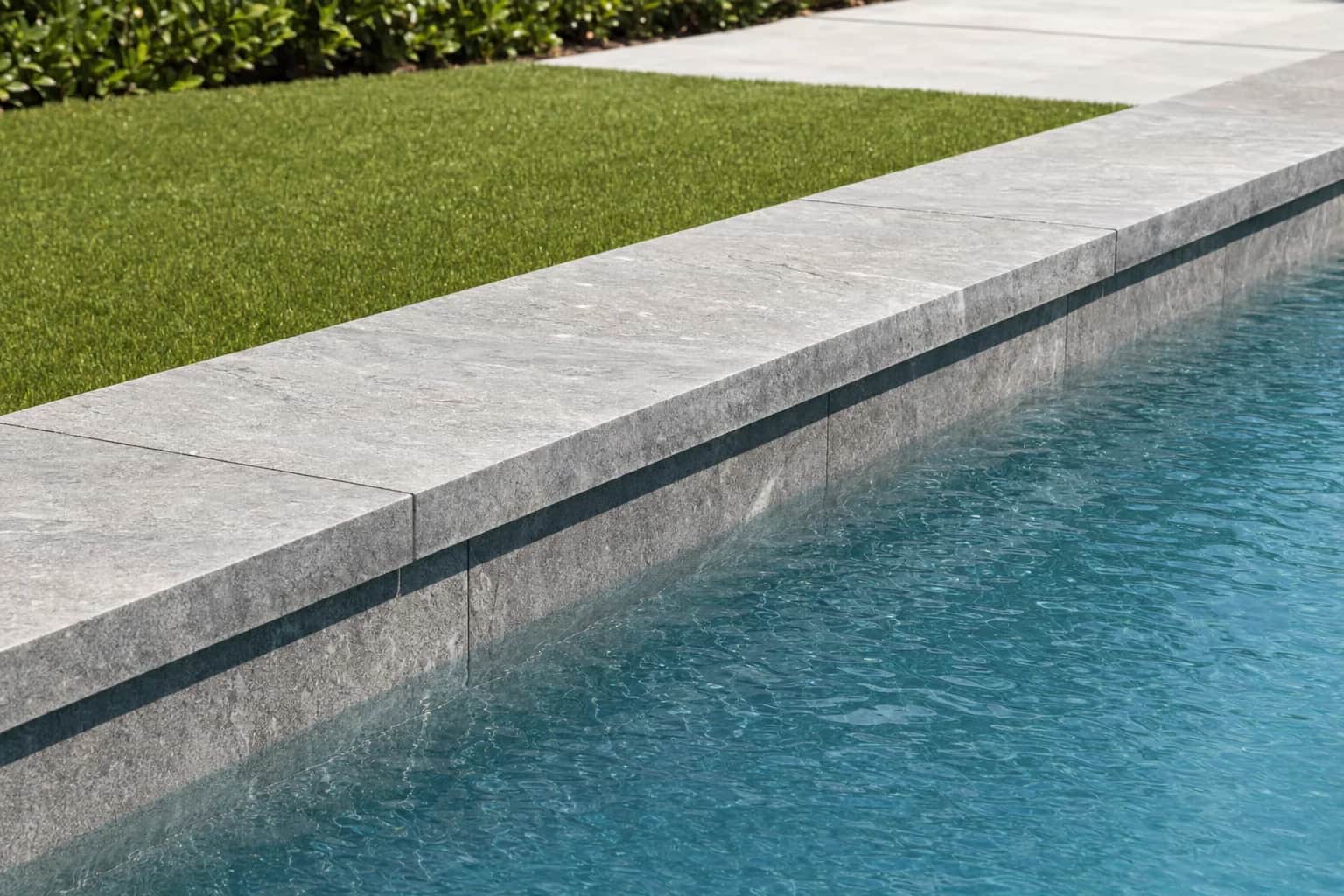 Drop face coping where the stone turns down and continues as a face on the pool wall