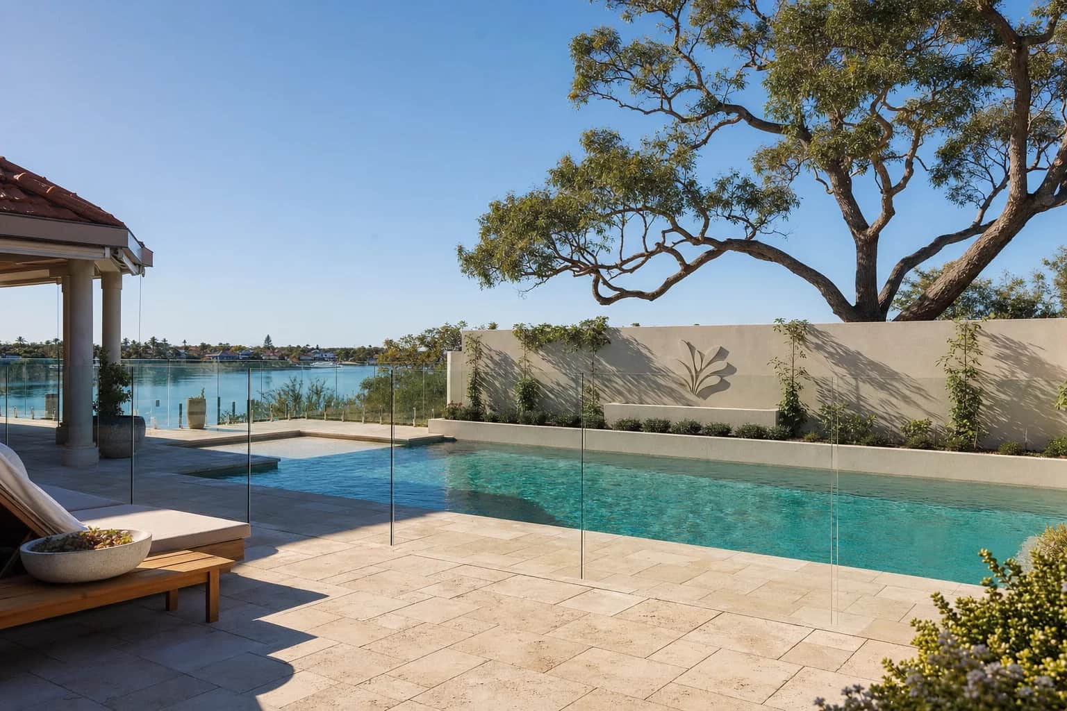 Cream travertine paving laid in a French pattern around a backyard swimming pool in Perth